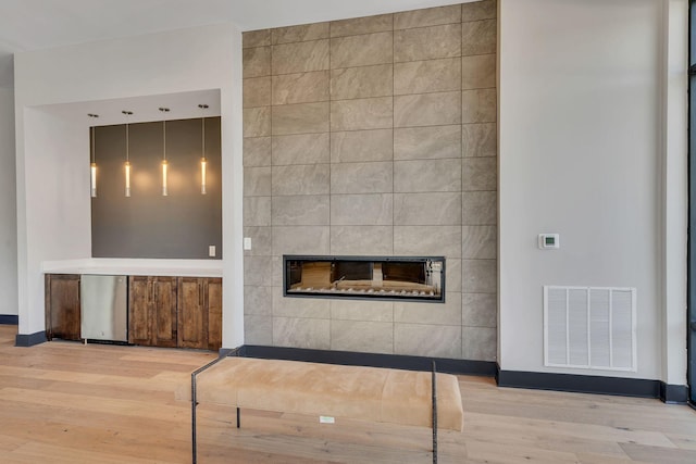 1677 54th Ave N Unit 318, Nashville, TN 37209 - unfurnished living room featuring a tile fireplace, wood finished floors, and baseboards