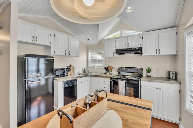 kitchen with black appliances, white cabinets, under cabinet range hood, and vaulted ceiling