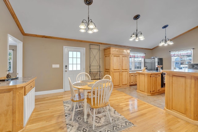 dining space with an inviting chandelier, light wood-style floors, lofted ceiling, and crown molding