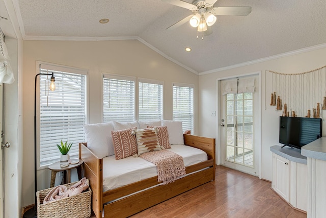 bedroom featuring ornamental molding, a textured ceiling, light wood-type flooring, vaulted ceiling, and access to exterior