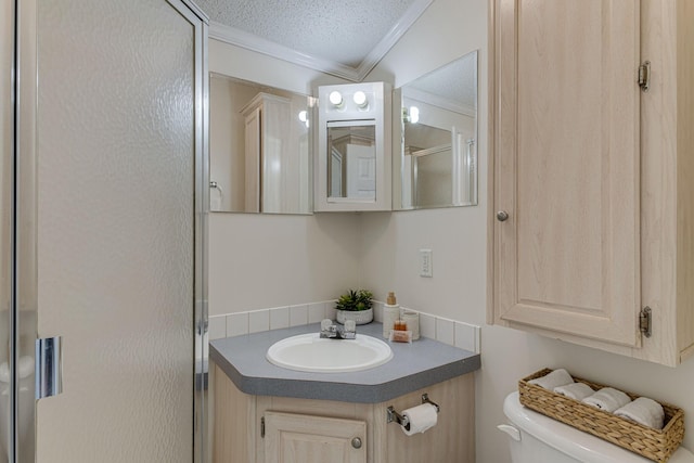 bathroom with vanity, toilet, and crown molding