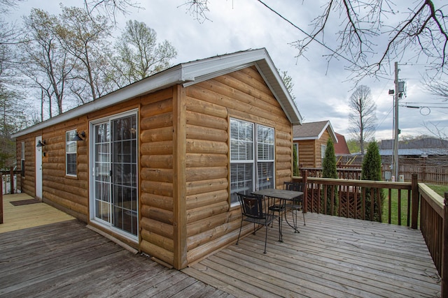 deck featuring outdoor dining area and fence