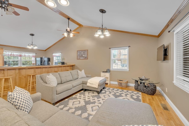 living area with light wood finished floors, visible vents, ceiling fan with notable chandelier, and a healthy amount of sunlight