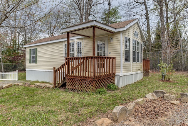 back of house with a yard, fence, and a wooden deck