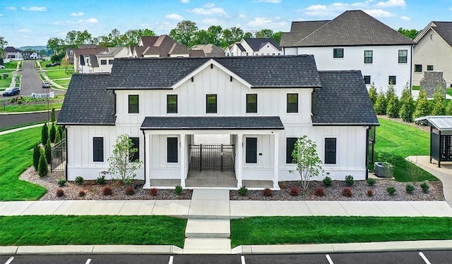 modern inspired farmhouse featuring board and batten siding, roof with shingles, covered porch, and a residential view