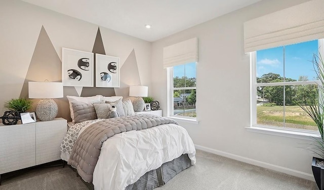 bedroom featuring baseboards and dark carpet