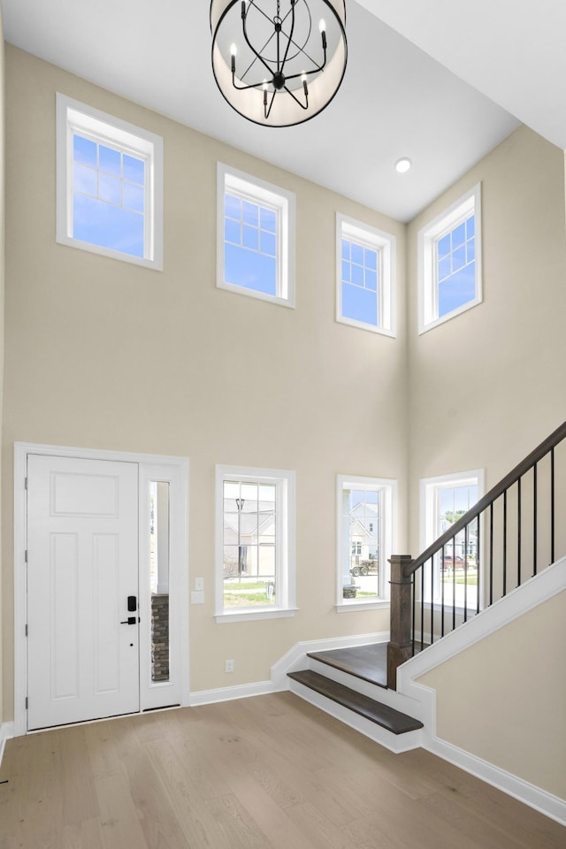 5958 Hunt Valley Dr, Spring Hill, TN 37174 - entryway with wood finished floors, a high ceiling, a chandelier, and stairway