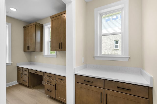 5958 Hunt Valley Dr, Spring Hill, TN 37174 - kitchen featuring light wood-style flooring, light countertops, and brown cabinetry