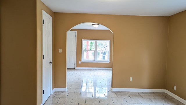 624 W Eastland St, Gallatin, TN 37066 - empty room featuring light tile patterned floors, baseboards, and arched walkways