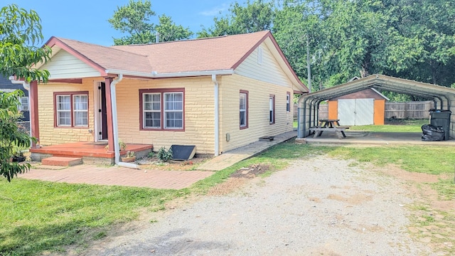 624 W Eastland St, Gallatin, TN 37066 - view of front of property featuring a storage shed, fence, an outbuilding, a shingled roof, and a detached carport