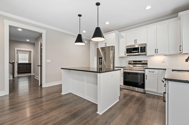 kitchen featuring dark countertops, stainless steel appliances, white cabinetry, dark wood-type flooring, and decorative backsplash