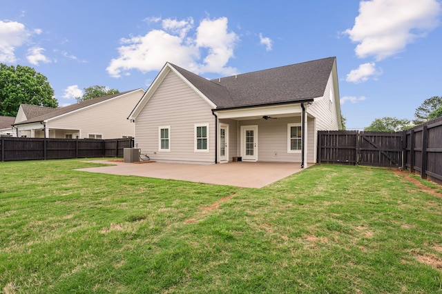 back of property featuring a fenced backyard, a patio area, a ceiling fan, and a yard