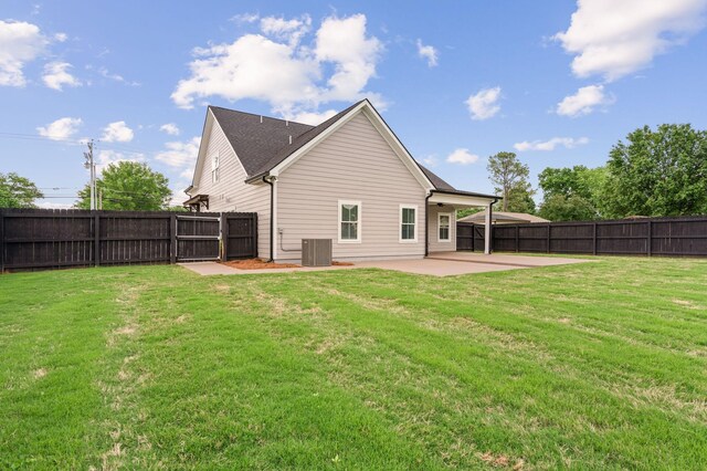 back of property with a patio, a lawn, and a fenced backyard