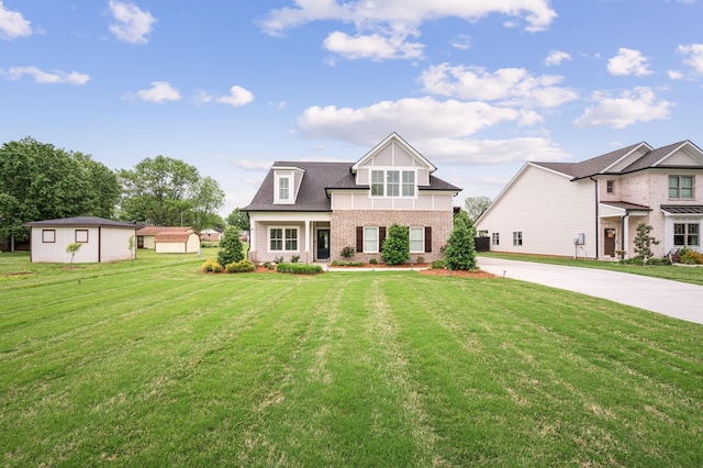 view of front of home featuring concrete driveway, brick siding, and a front yard