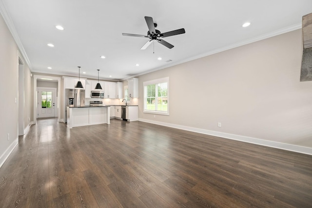 unfurnished living room featuring dark wood-style flooring, ornamental molding, and recessed lighting