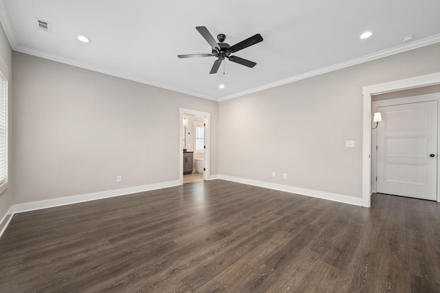 empty room with ornamental molding, visible vents, dark wood finished floors, a ceiling fan, and baseboards