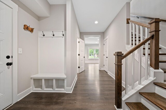 mudroom with baseboards, dark wood finished floors, and recessed lighting
