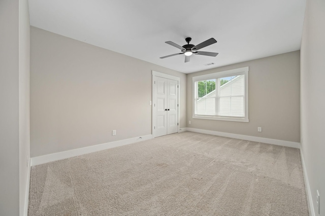 spare room featuring visible vents, baseboards, ceiling fan, and carpet floors