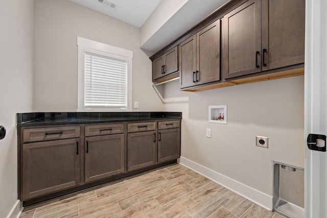 washroom with baseboards, hookup for a washing machine, visible vents, cabinet space, and electric dryer hookup