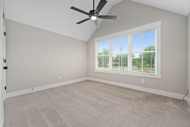 spare room with vaulted ceiling, baseboards, and a ceiling fan
