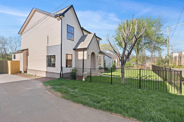 736 Douglas Ave, Nashville, TN 37207 - view of side of property with a yard, board and batten siding, and fence