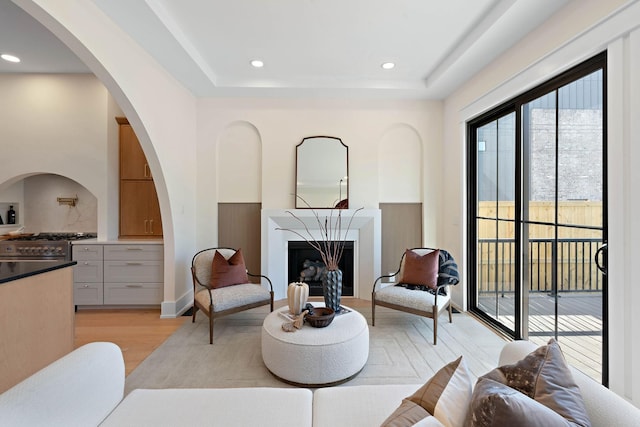 736 Douglas Ave, Nashville, TN 37207 - living room featuring arched walkways, light wood-style floors, a fireplace, and recessed lighting