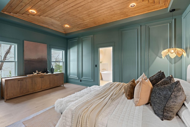 736 Douglas Ave, Nashville, TN 37207 - bedroom featuring wood ceiling, a tray ceiling, light wood-type flooring, ensuite bathroom, and a decorative wall