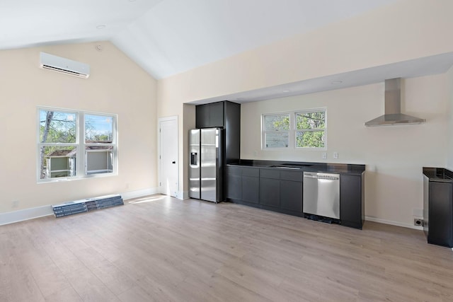 736 Douglas Ave, Nashville, TN 37207 - kitchen with wall chimney range hood, stainless steel appliances, light wood-style flooring, and a wall mounted AC