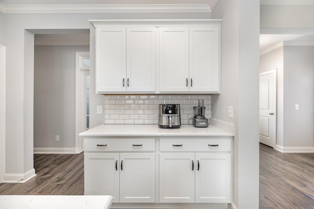 5509 Dana Ln, Franklin, TN 37064 - kitchen with baseboards, crown molding, dark wood-type flooring, backsplash, and light countertops