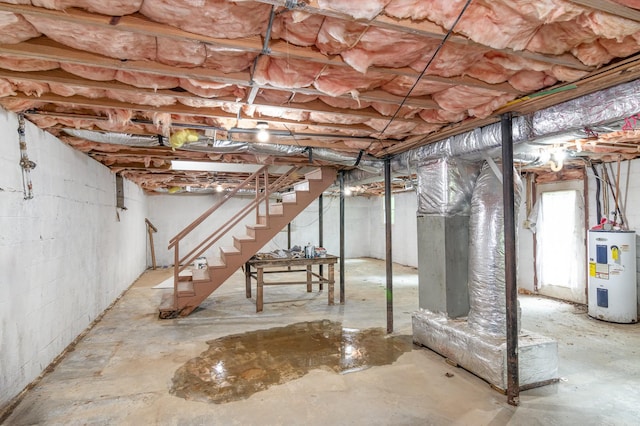 basement featuring stairway and water heater