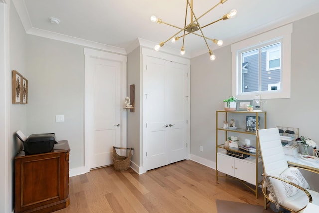 office space featuring baseboards, a notable chandelier, light wood-style flooring, and crown molding