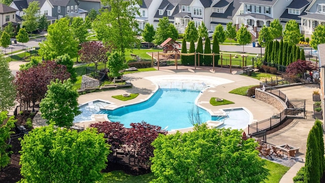 community pool with fence and a residential view