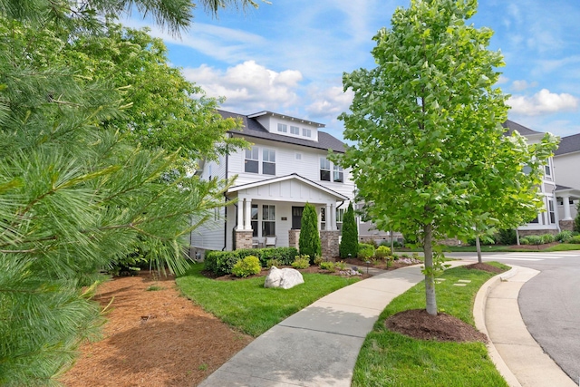 american foursquare style home featuring brick siding