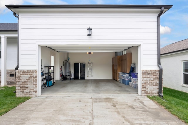 garage featuring water heater and driveway