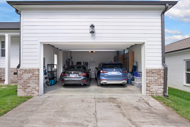 garage with concrete driveway and a garage door opener