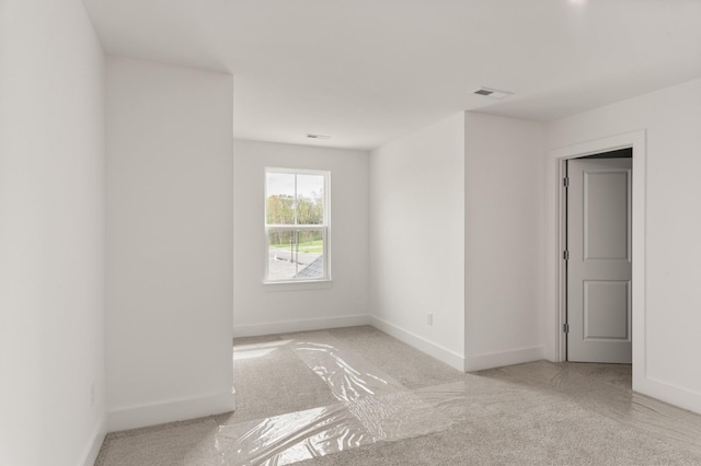 empty room with light carpet, baseboards, and visible vents