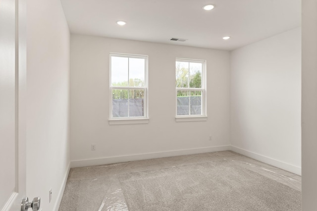 spare room with baseboards, recessed lighting, visible vents, and carpet floors