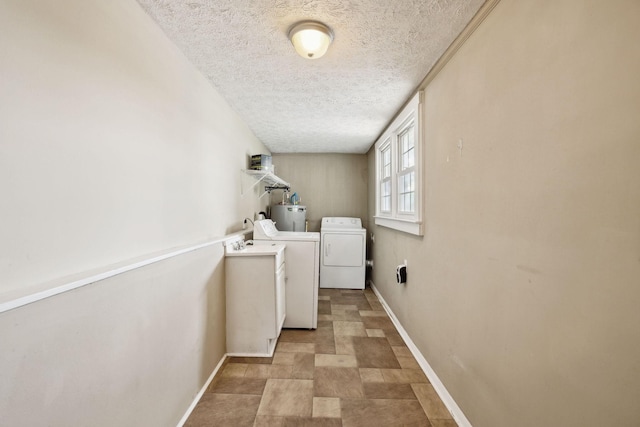 laundry room featuring laundry area, a textured ceiling, washer and dryer, electric water heater, and baseboards