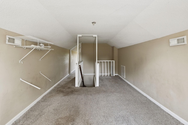 bonus room with carpet, visible vents, and lofted ceiling