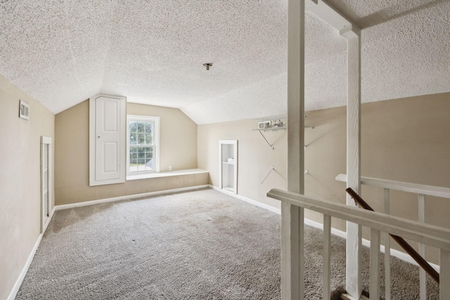 bonus room with a textured ceiling, baseboards, visible vents, vaulted ceiling, and carpet floors