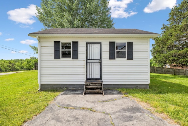 view of outbuilding featuring entry steps and fence