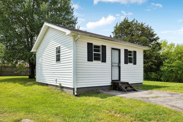 view of outbuilding with entry steps and fence