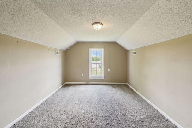 bonus room with carpet flooring, visible vents, baseboards, and lofted ceiling