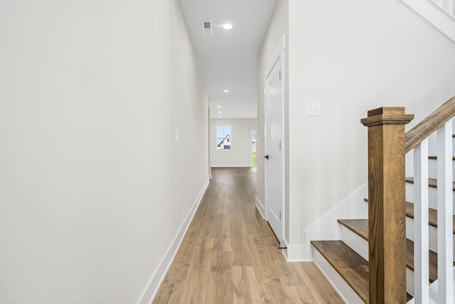 10114 Bighorn Ln, Bell Buckle, TN 37020 - corridor featuring baseboards, stairs, light wood-style flooring, and visible vents