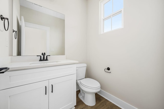 10114 Bighorn Ln, Bell Buckle, TN 37020 - bathroom featuring toilet, wood finished floors, vanity, visible vents, and baseboards