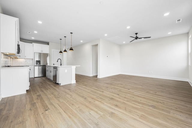 10114 Bighorn Ln, Bell Buckle, TN 37020 - kitchen featuring a ceiling fan, a sink, open floor plan, a kitchen island with sink, and appliances with stainless steel finishes