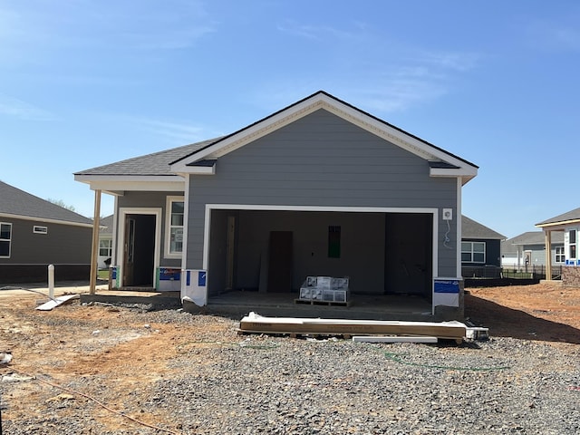 property in mid-construction featuring a sunroom, a garage, and fence