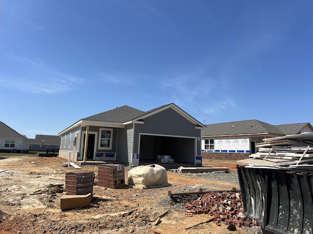 back of property featuring an attached garage