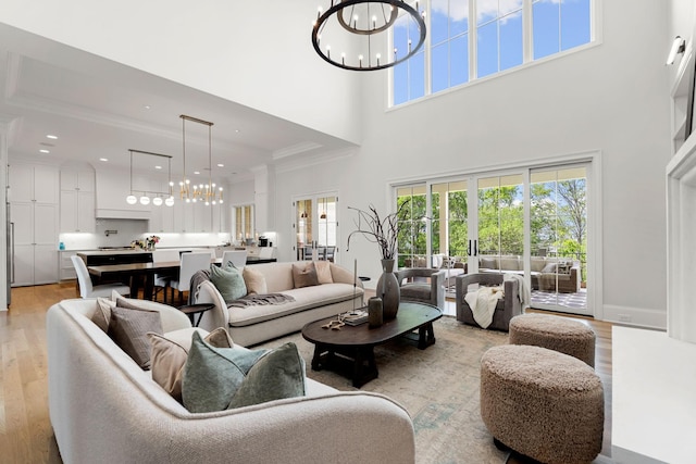 9316 Edenwilde Dr, Brentwood, TN 37027 - living area featuring recessed lighting, crown molding, light wood-style flooring, a high ceiling, and a notable chandelier