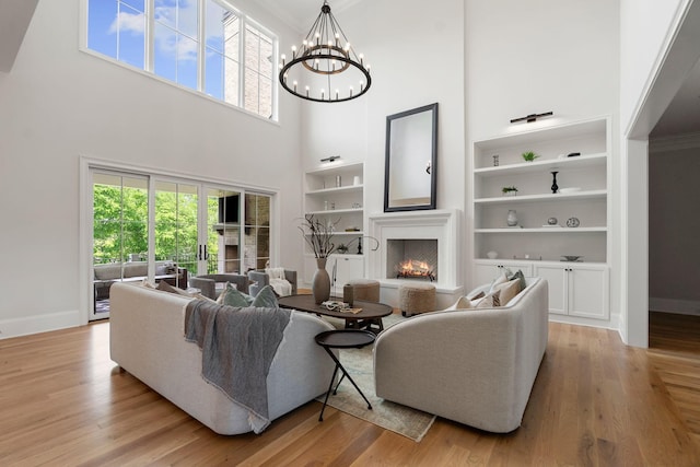 9316 Edenwilde Dr, Brentwood, TN 37027 - living room with plenty of natural light, a warm lit fireplace, baseboards, and a high ceiling